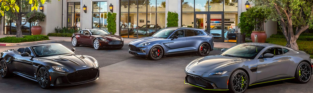 Outside of Aston Martin Dealership with Aston Martins parked in front